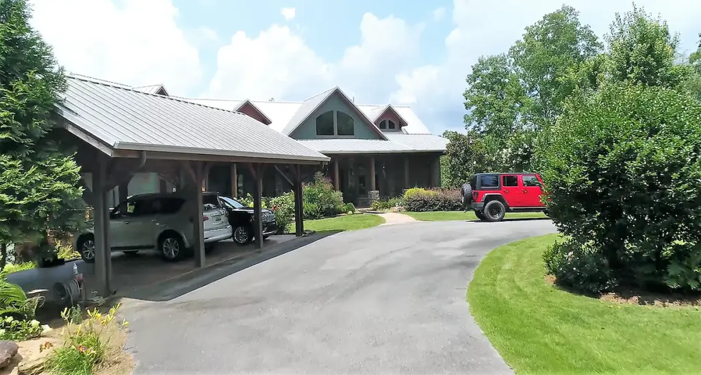 Custom built home with cars parked in driveway